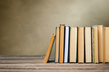 School blackboard with pile of books