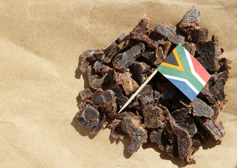 Biltong (protein snack) on brown paper, this is a traditional food snack that can be found in South Africa. This image has selective focusing.