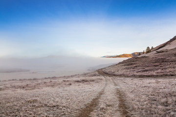 Country Road in a fog in the mountains.