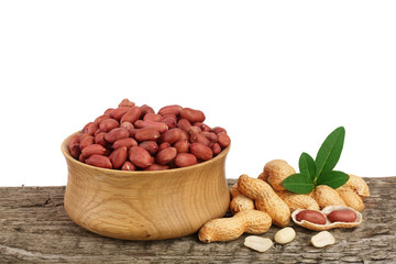 peanuts with leaf in bowl on old wooden background