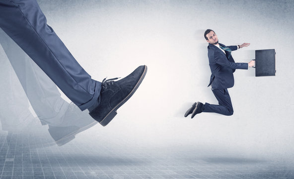 Businessman Foot Kicking Small Businessman