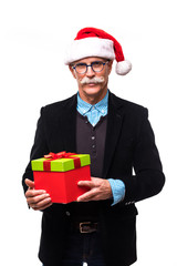 Senior business man with Santa Claus hat and Christmas present on white background