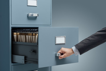 Office clerk searching files