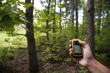Finding position with gps device outdoor. Background blur.