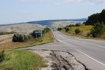 Country summer landscape with a road. Hitch-hiking on the roadside