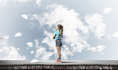 Concept of careless happy childhood with girl looking far away