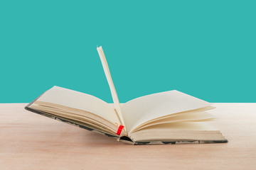 open book old on wooden floor isolated on blue background with copy space add text  ( high definition image )