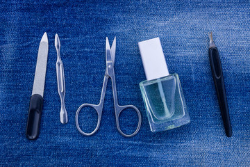 Basic set of manicure tools on jeans background