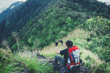 Fototapeta premium Tourist trail hiking in the forest Traveler Man with backpack crossing the mountain