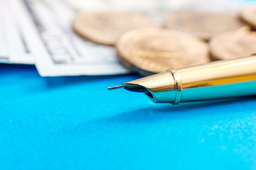 Pen on money background. Close up. Business background.