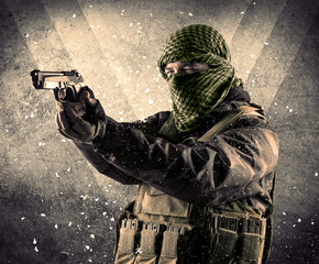 Portrait of a dangerous masked armed soldier with grungy background