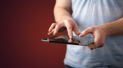 Close up of hand holding digital touchpad tablet device