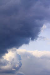 Fototapeta na wymiar Background of blue dramatic clouds in the dark sky before a thunderstorm.
