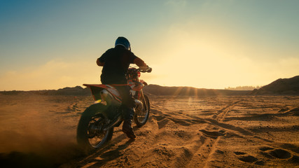 Shot of the Professional Motocross Driver Riding on His FMX Motorcycle on the Extreme Off-Road...