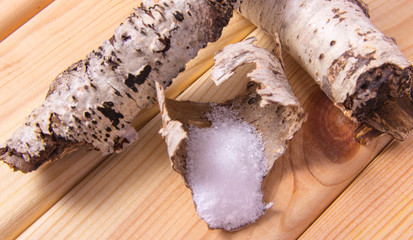 Xylitol - sugar substitute. Birch sugar on wooden background.