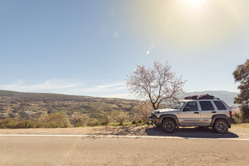 Obraz na płótnie Canvas 4x4 car on road side in mountains