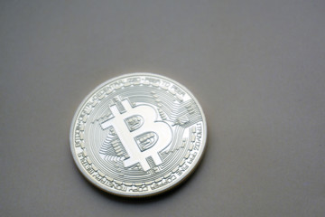 Golden Bitcoins (digital virtual money) on a black gray background.