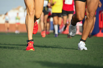 Marathon running race, people feet on the lawn