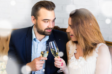 new year celebration - young beautiful couple with glasses of champagne