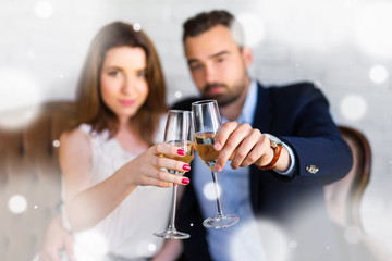 new year celebration - happy couple with glasses of champagne at restaurant