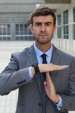 Businessman requesting a break with a hands gesture 