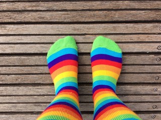 Rainbow colored socks on dock