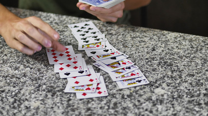 Obraz premium Two young men relaxing together and playing cards spending time at home.