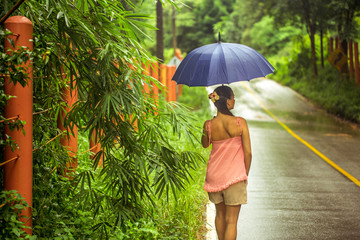 girl with umbrella on the road