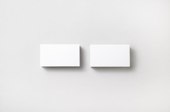 Blank business cards on paper background. Template for branding identity. Studio shot.