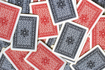 Texture of red and blue playing cards back spread on a table
