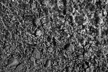texture of water on stones in a crooked stream