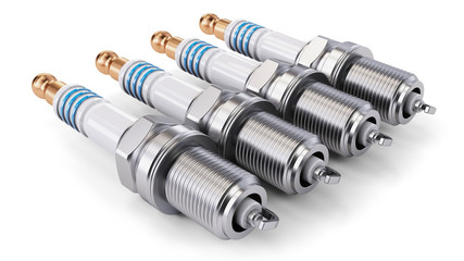 Four spark plugs arranged in a row on a white background