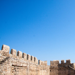 view of medieval castle’s wall on the background of blue sky, Rhodes, Greece