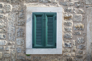 Fototapeta na wymiar Wooden window shutters - Closed old shuttered weathered wooden window