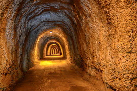 Pedestrian tunnel in the rock with illumination