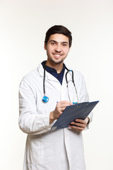 beautiful young doctor in a dressing gown with a stethoscope on a white background in the studio