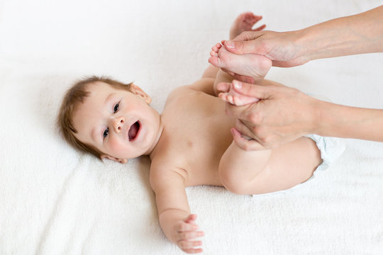 Mother makes massage for baby foot