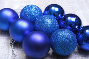 Blue christmas balls on a wooden background