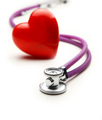 Heart with a medical stethoscope, isolated on wooden background