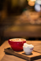 cup of coffee with marshmallow on wooden table