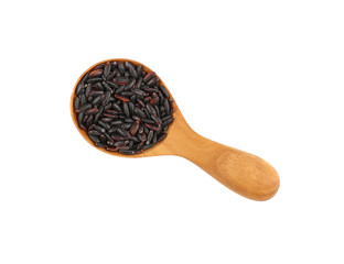 Black purple raw rice in wooden scoop on white