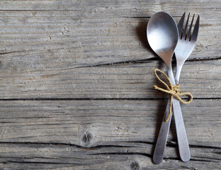 Cutlery set:fork and spoon on rustic wooden table.Cutlery on old wooden background.Can be used as...
