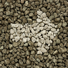 Arrow  from light gravel on dark gravel background