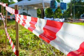 Red and white tripped tape fence for barricades or murder zones or crime scene.