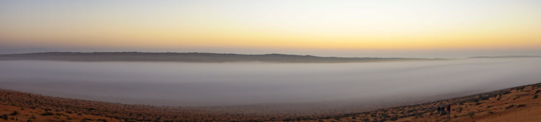Fototapeta na wymiar Panoramic of Sunrise in Wahiba Sands desert in Oman with mist