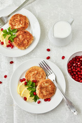 Roasted cauliflower meatballs with lemon and pomegranate and yogurt sauce on a white plate , top view. Healthy, vegetarian, dietary snack