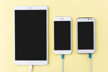charging cables with smartphone and tablet in top view