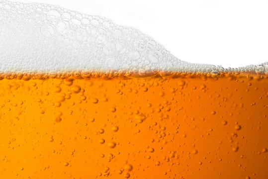 Bubble froth of beer in glass isolate on white background