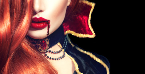 Halloween. Sexy vampire woman with dripping blood on her lips - obrazy, fototapety, plakaty