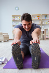 Young man exercising at home in sports and healthy lifestyle con